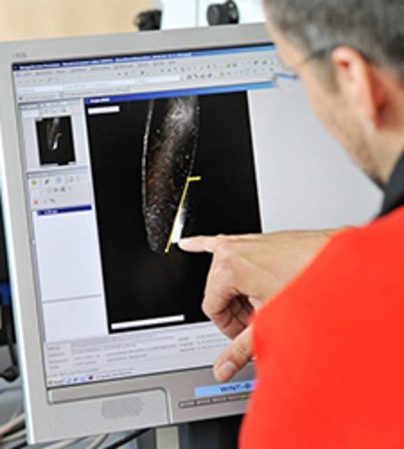 Employee Using a Coordinate Measuring Machine to Measure the Geometry of Part