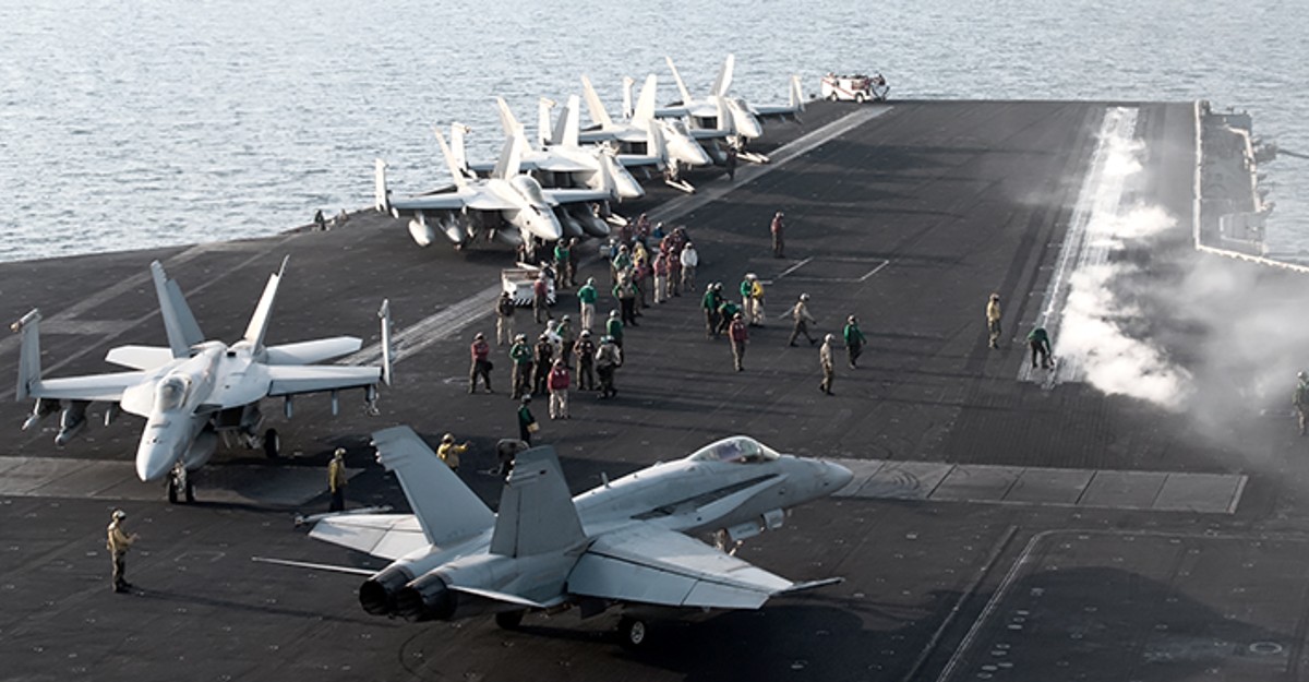 Military Planes and Personnel on a Landing in the Ocean