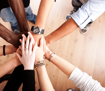 Group of Nine People Putting their Hands Together as a Team