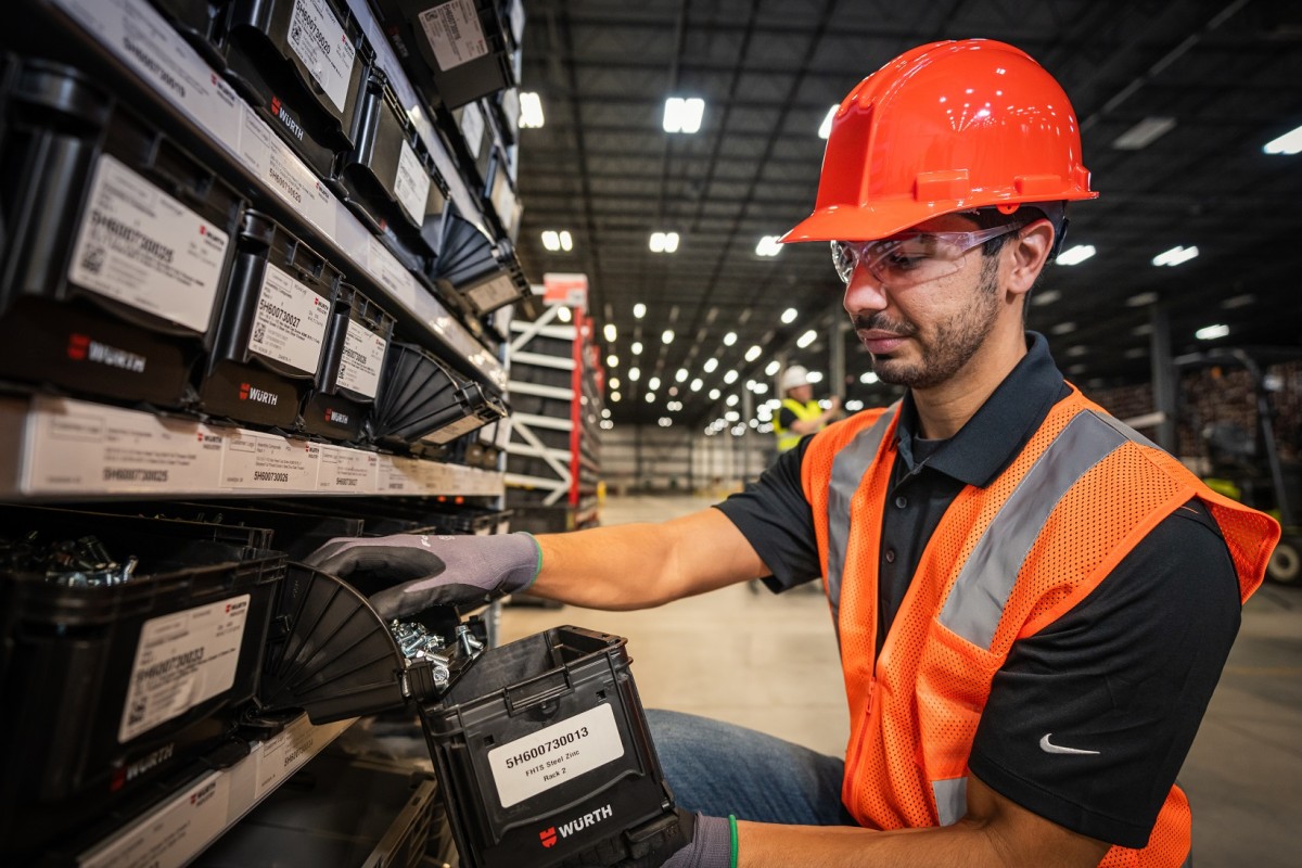 Würth customer taking fasteners from a Kanban rack and bin system Würth customer taking fasteners from a Kanban rack and bin system